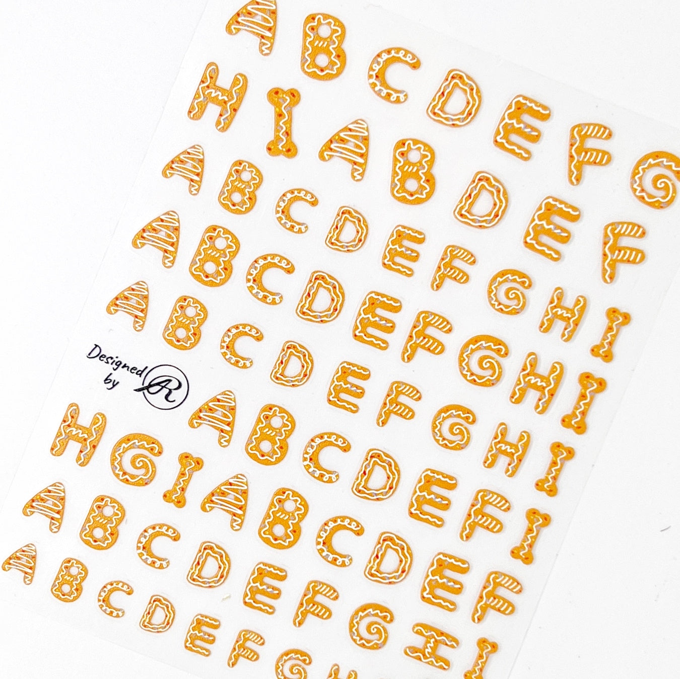 Gingerbread Letters Nail Stickers - Gingerbread Cookie-Inspired Alphabet Letters, Displayed on a White Background.