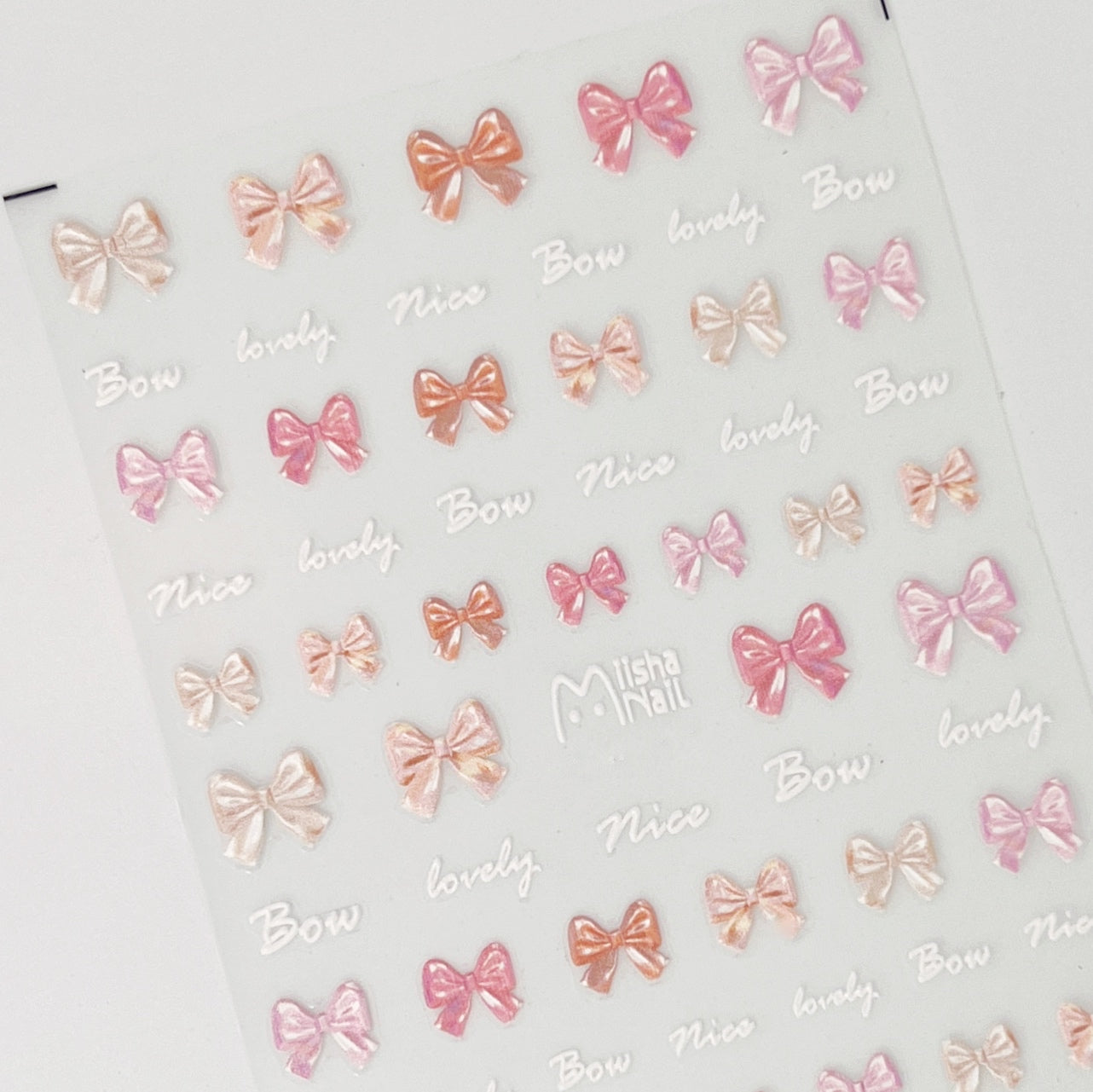 Pink and peach bow embossed nail stickers. 