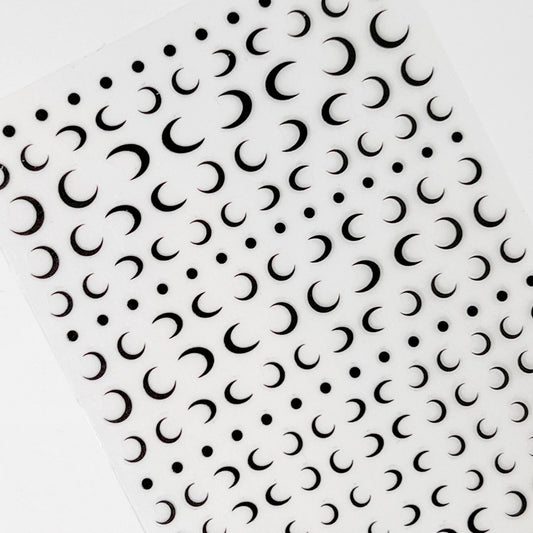 Crescent Moon Nail Stickers - Flat Black Moon Motifs on Clear Sheet, Presented on a White Background.