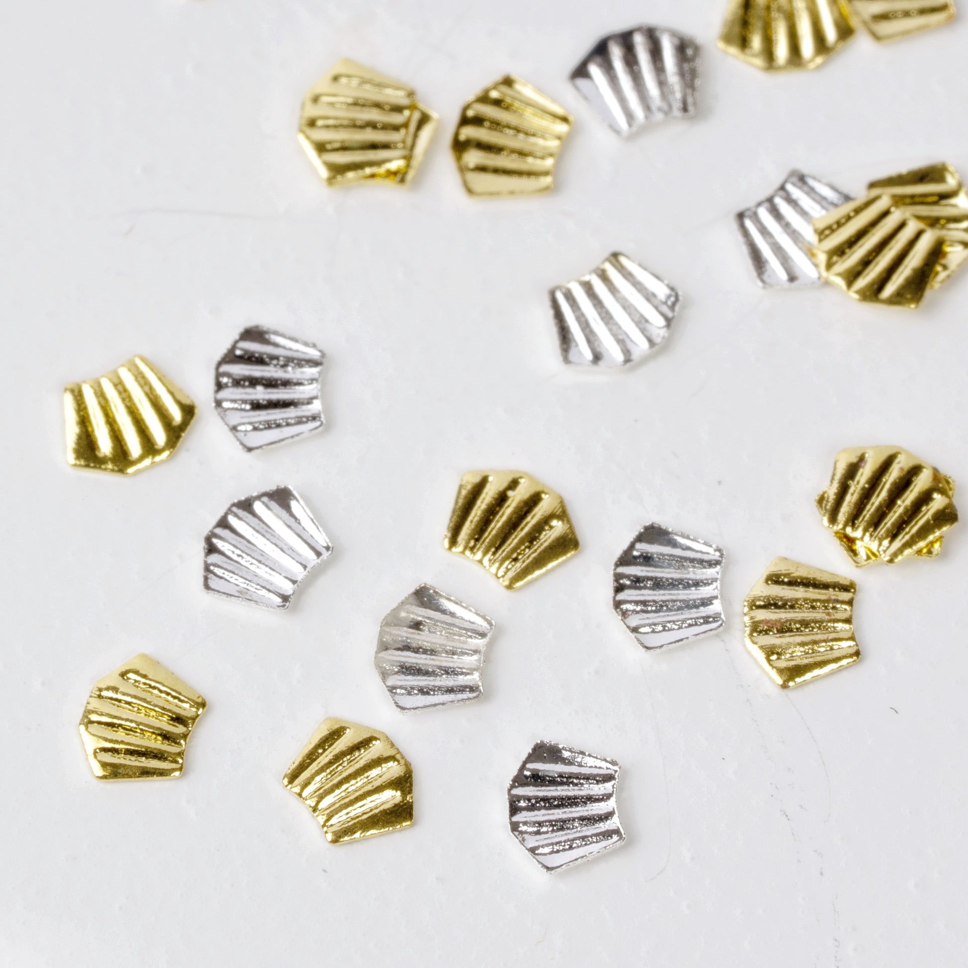 Nail charms scattered on white background.