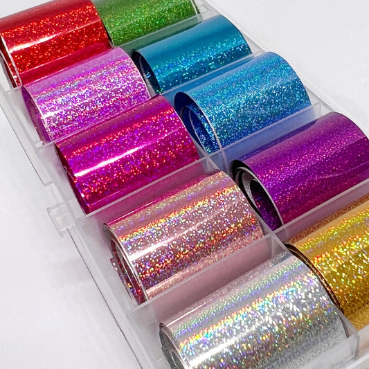 Holo Pixel Foil Set - 10 Holographic Printed Metallic Foils in Red, Lavender, Light Pink, Dark Pink, Silver, Green, Light Blue, Bright Blue, Purple, and Gold, Displayed in a Clear Case on a White Background."