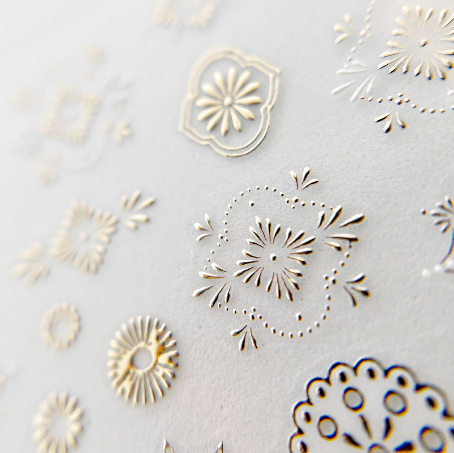 Ornate Detail Nail Stickers - Moroccan-Style Motifs in Metallic Champagne Color with Raised Texture, Presented on White Background