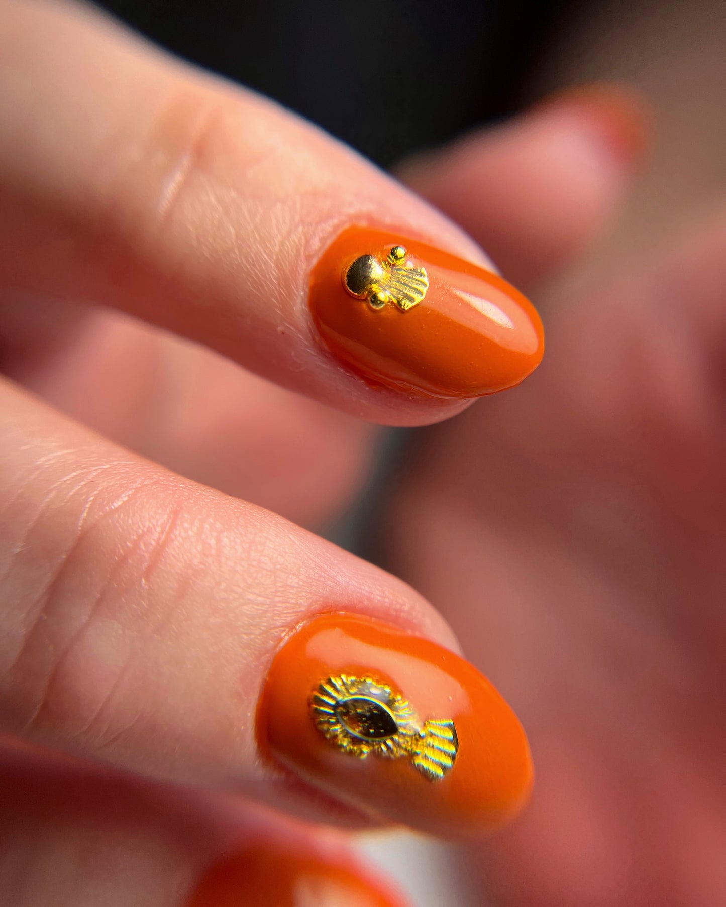 Close up of manicure featuring Scallop Fringe Nail Charms. 