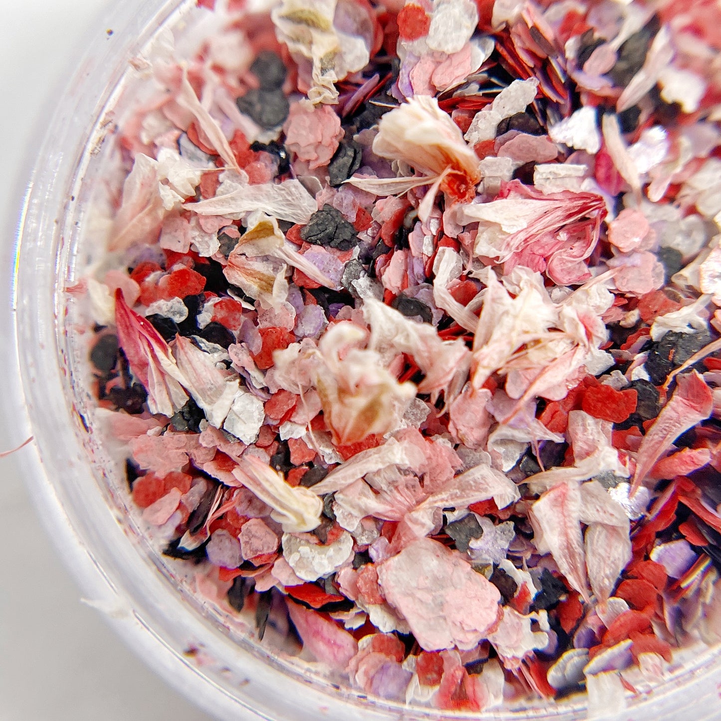 Confetti Crush Collection in Rose Crush - Colorful Mix of Mica Speckles and Dried Flower Petals in Jars, Featuring Pink, Red, Black, and White Colors, on White Background.