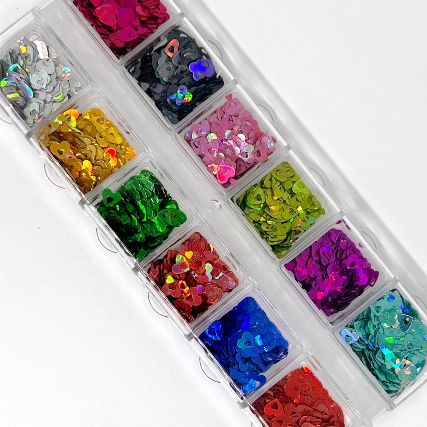 Hollow Hearts Glitter Mix - Multi-Size Colorful Hollow and Mini Heart-Shaped Glitters in a 12-Grid Palette, Ideal for Precise Color Selection, Pictured on a White Background.