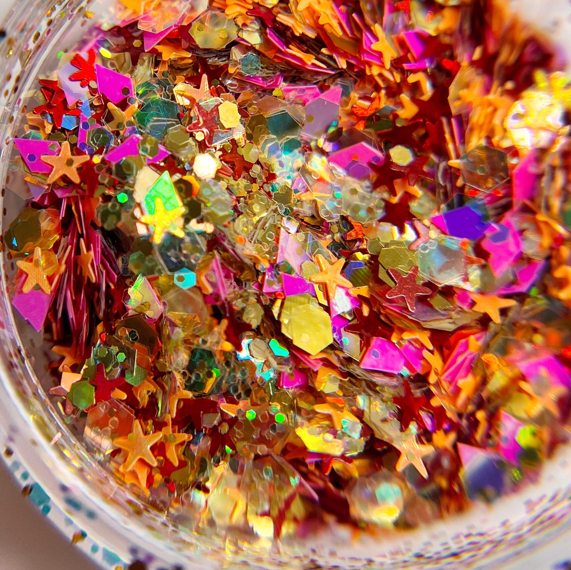 Detailed view of glitter in clear jar on white background. 
