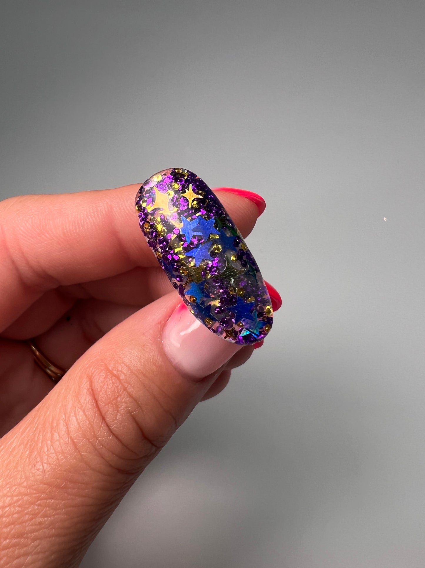 Hand holding decorated nail tip