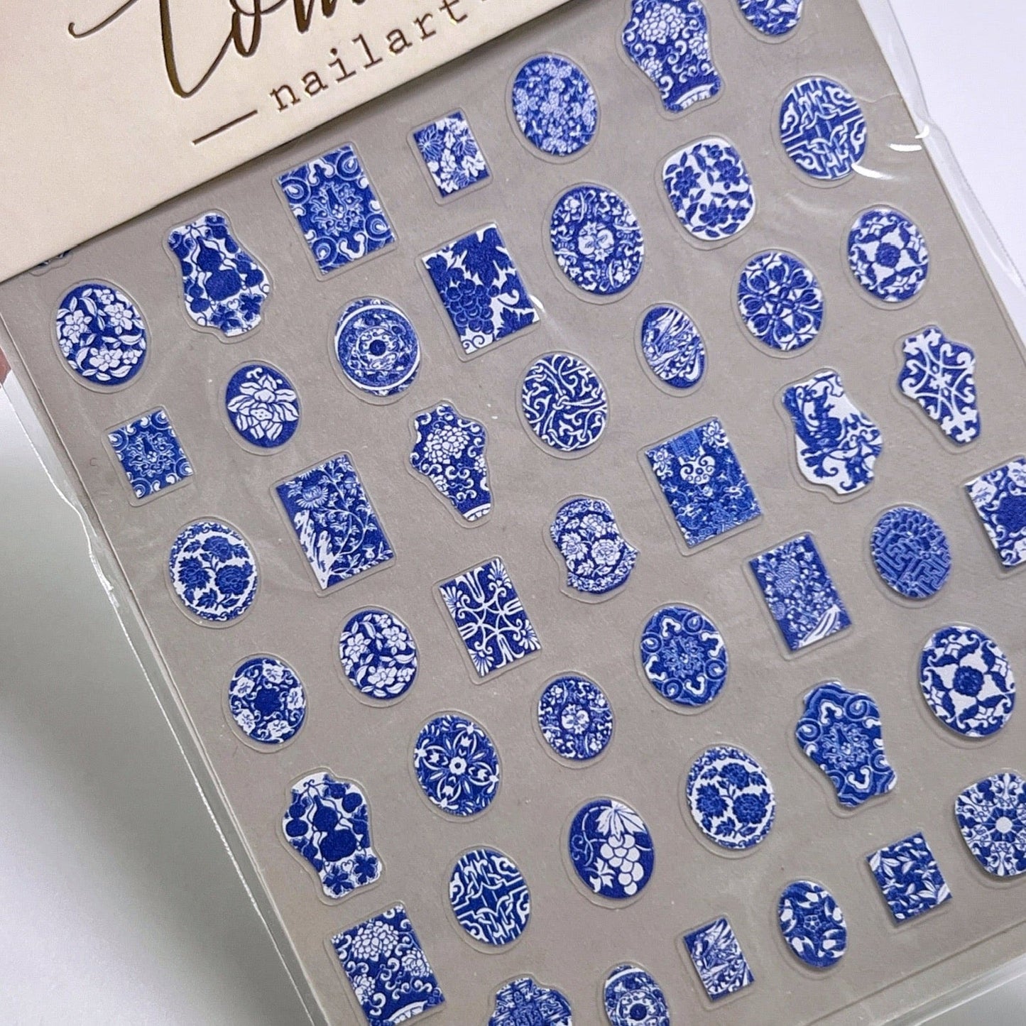 Cameo style nail stickers with blue and white floral motifs. 