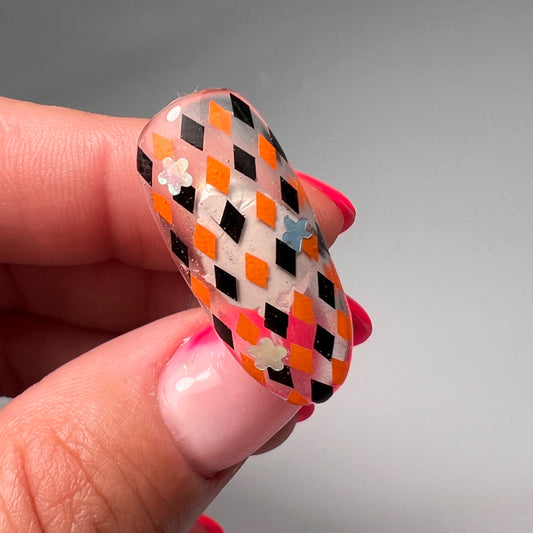 Hand holding decorated nail tips