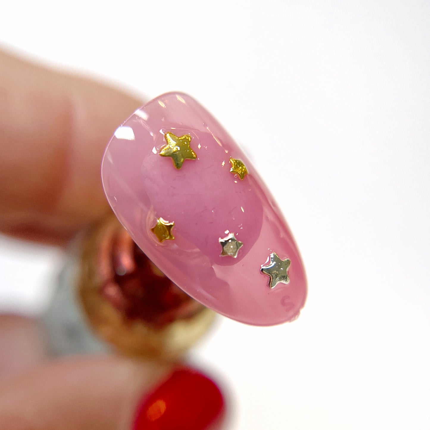 Hand holding decorated nail tip