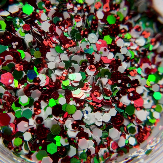 Video of Detailed view of red, green and white hexagon glitter mix. 
