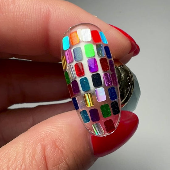 Hand holding decorated  nail tip. 