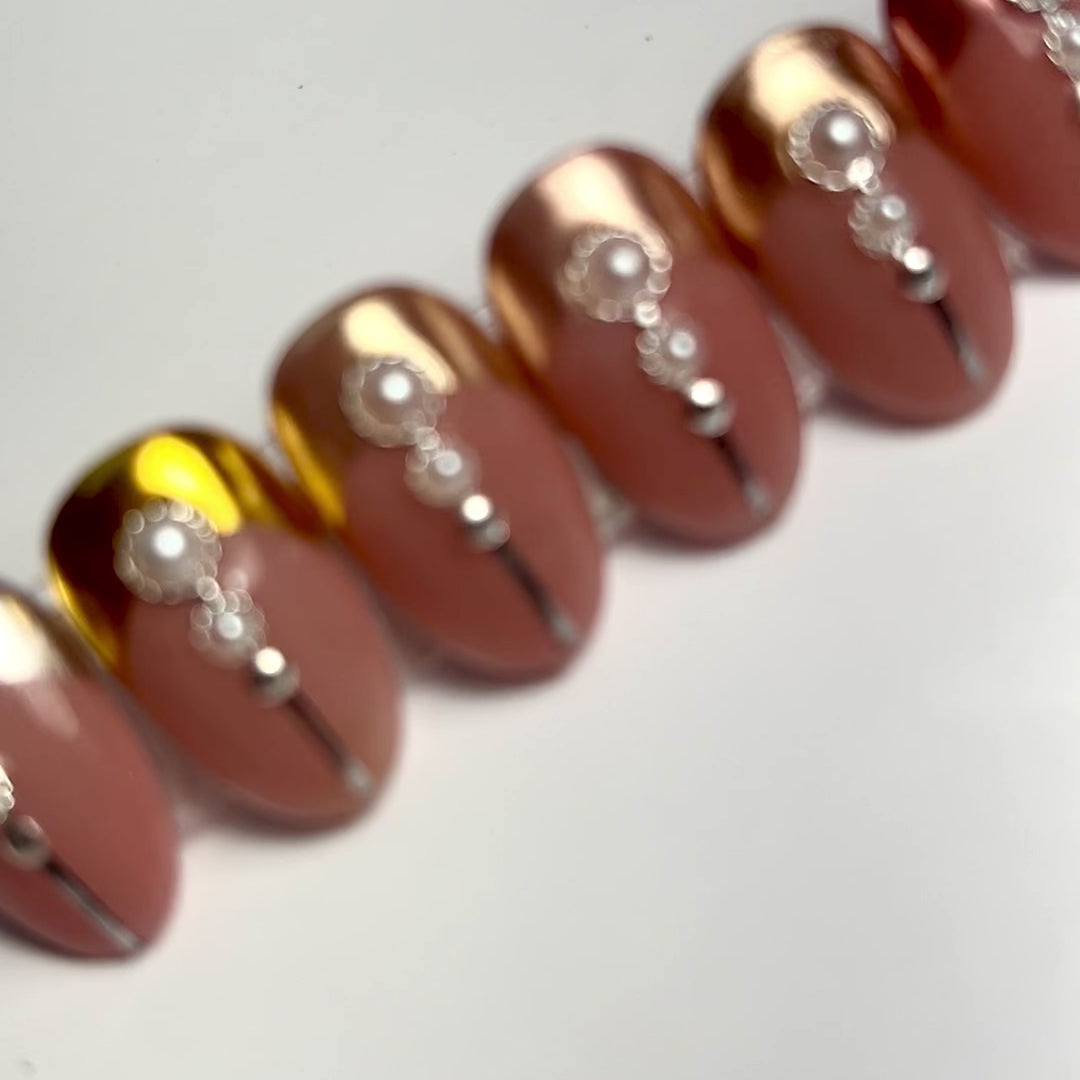 Video of decorated nail tips on white background. 