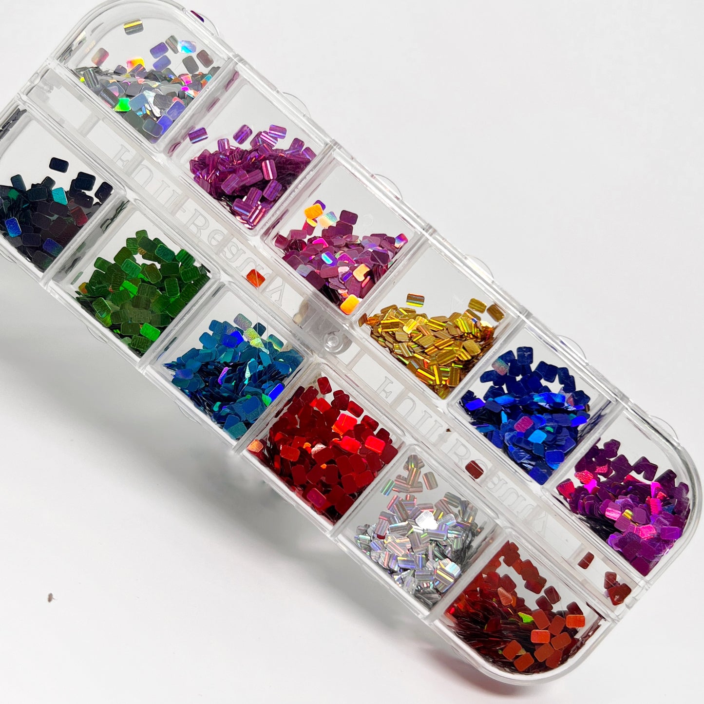 Glitter set in clear case on white background. 