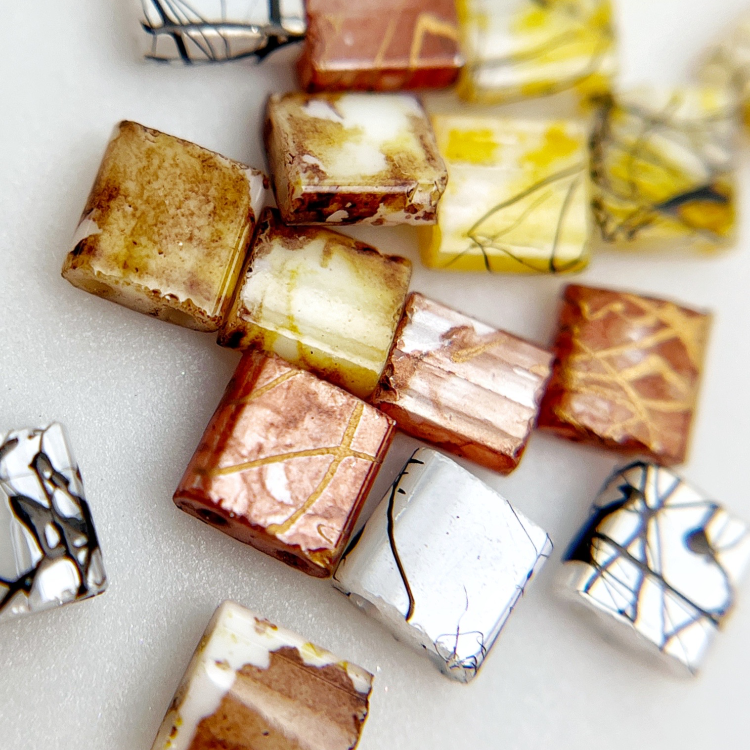 Multicolor square resin nail charms on white background. 