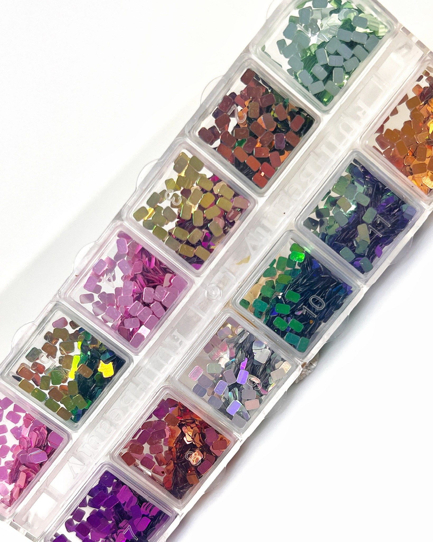 Glitter set in clear case on white background. 