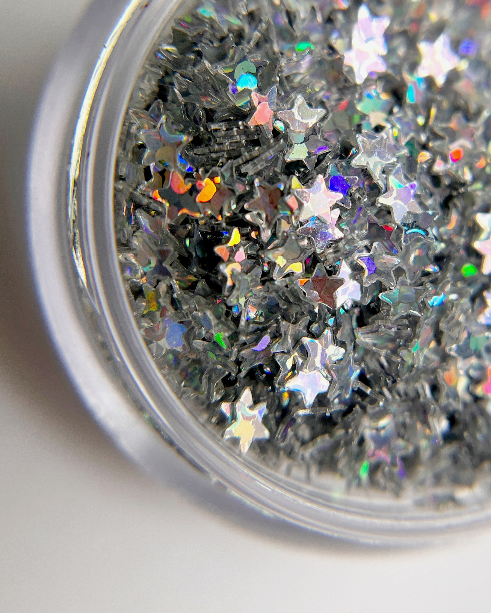 Silver star glitter in clear jar. 