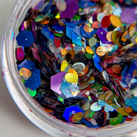 Glitter mix in clear jar on white background. 