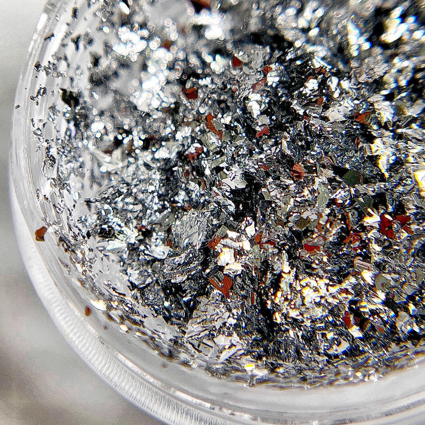 Thin silver foil flakes for nail art. 