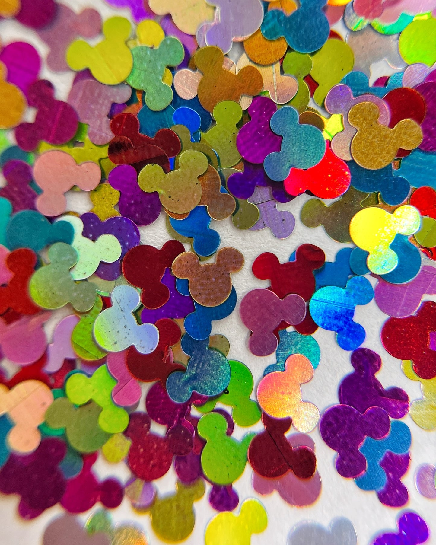 Mutlicolor glitter mix scattered on white background. 